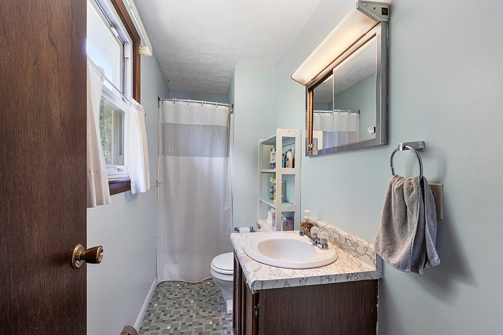 4 Ridgemont Drive Londonderry, NH 03053 - Photo 19 of 33 a bathroom with a sink and a mirror