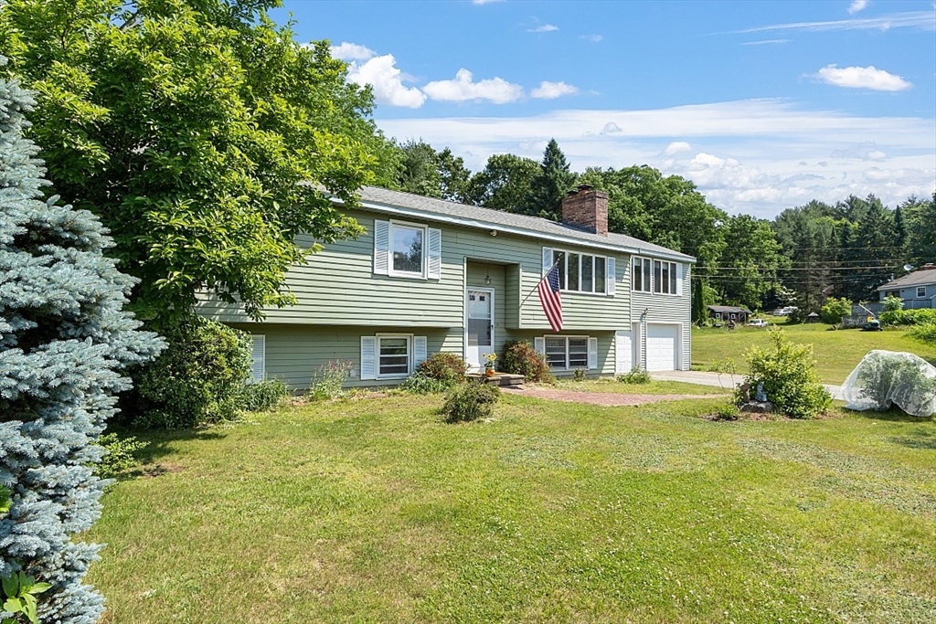 4 Ridgemont Drive Londonderry, NH 03053 - Photo 2 of 33 a front view of a house with a yard