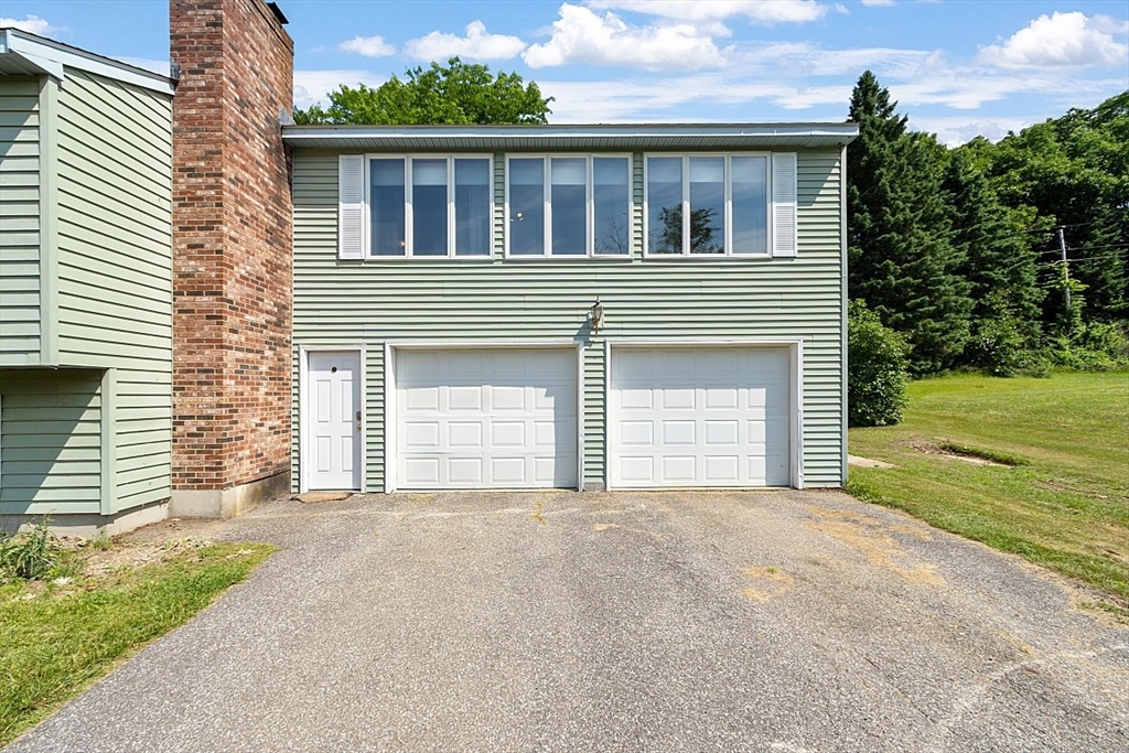 4 Ridgemont Drive Londonderry, NH 03053 - Photo 5 of 33 a front view of a house with a garage