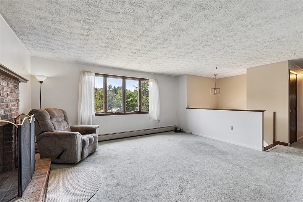 4 Ridgemont Drive Londonderry, NH 03053 - Photo 7 of 33 a living room with furniture and a large window