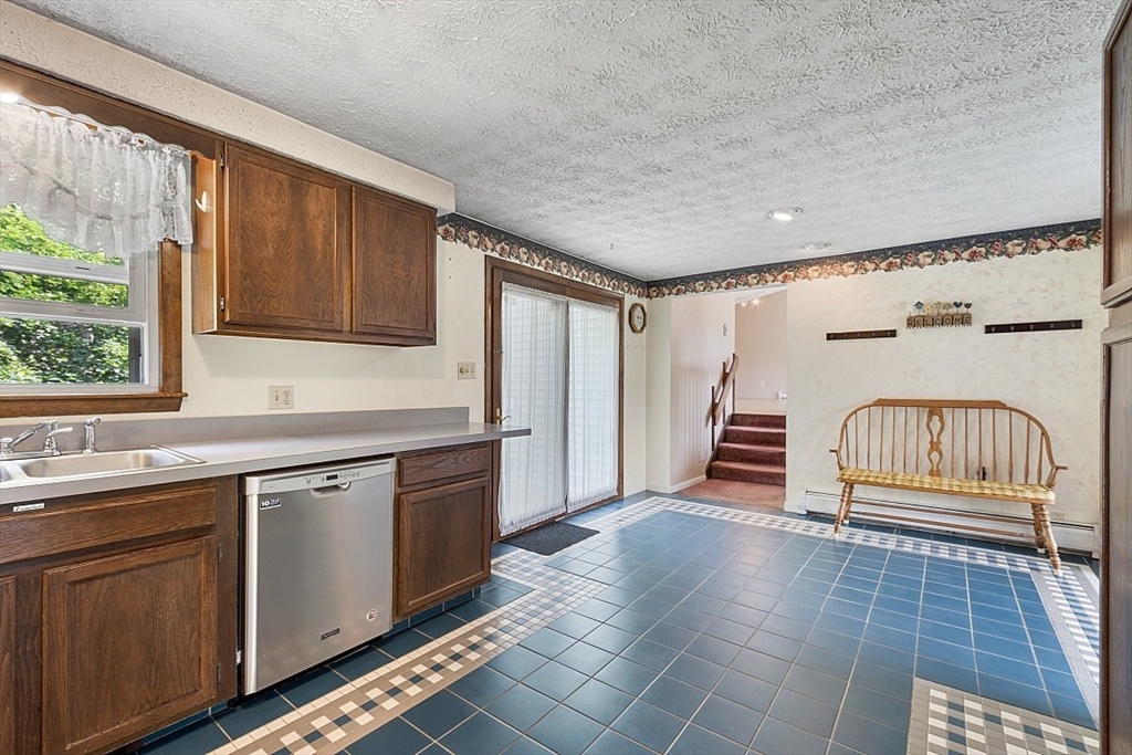 4 Ridgemont Drive Londonderry, NH 03053 - Photo 10 of 33 a kitchen with granite countertop a stove a sink and a microwave