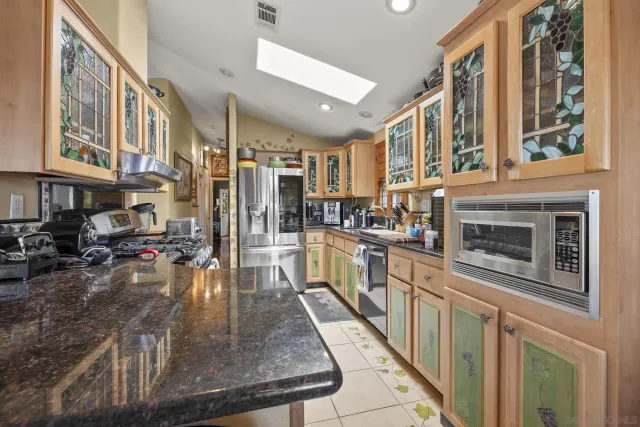 a kitchen with stainless steel appliances granite countertop a stove and a sink