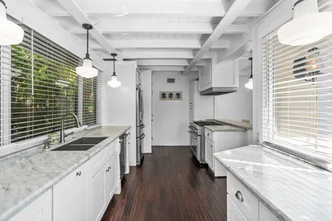 a kitchen with stainless steel appliances granite countertop a stove and a refrigerator
