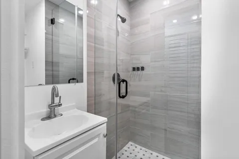 a bedroom with a bed a flat screen tv and a potted plant