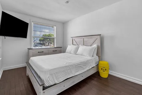 a bedroom with a bed and a flat screen tv