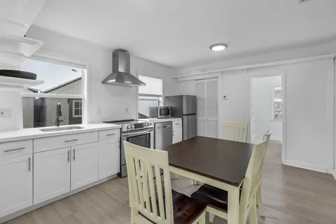 a kitchen with granite countertop a stove and a refrigerator