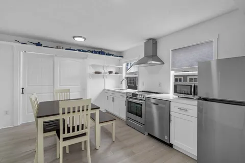 a bedroom with a bed and large windows