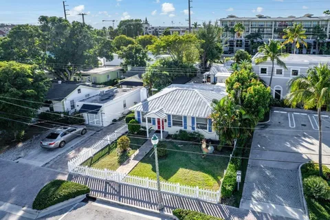 an aerial view of a house with garden space and street view