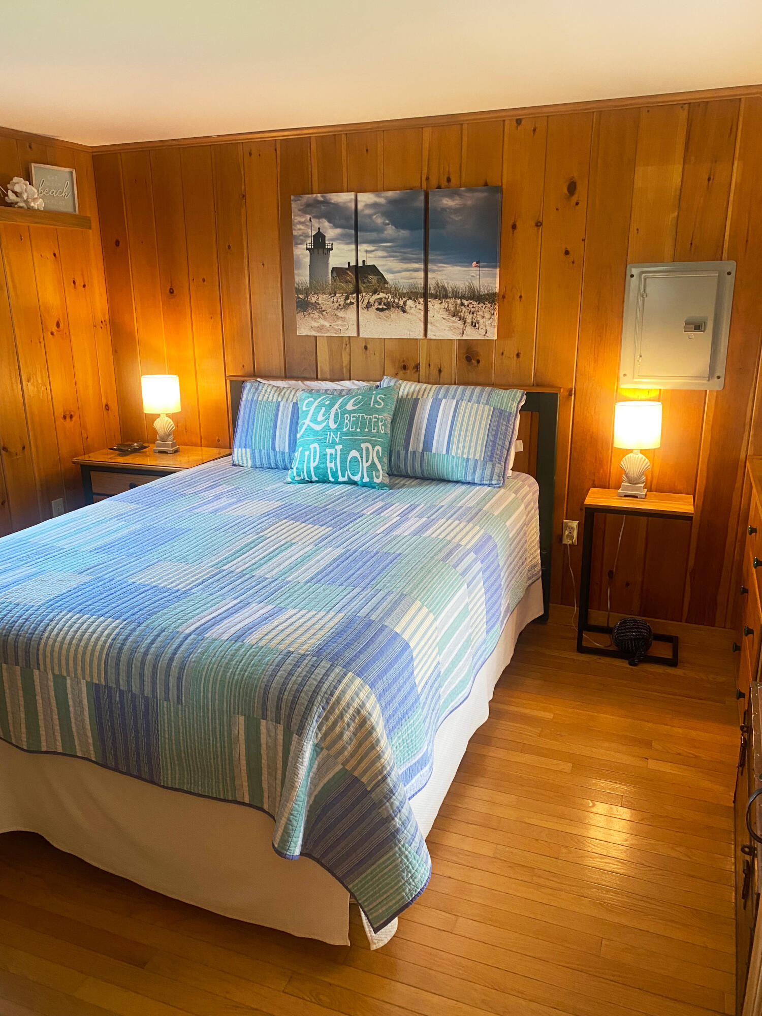 1090 Craigville Beach Road Centerville, MA 02632 - Photo 12 of 33 a bed sitting in a bedroom next to a lamp