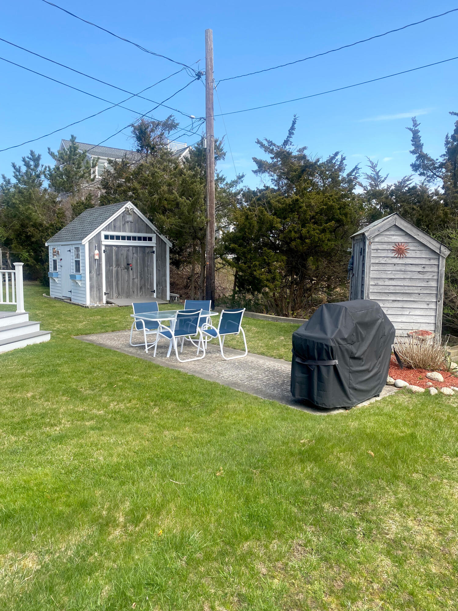 1090 Craigville Beach Road Centerville, MA 02632 - Photo 9 of 33 a view of a house with a backyard and a patio
