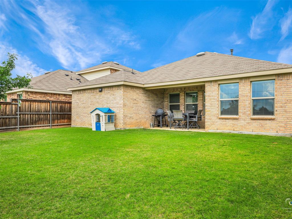 4517 Ashmark Road Aubrey, TX 76227 - Photo 23 of 26 a front view of a house with a garden