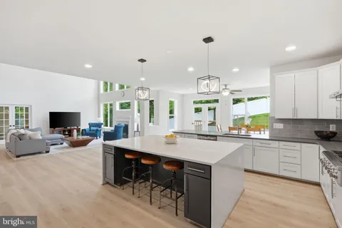 a kitchen with sink refrigerator and microwave