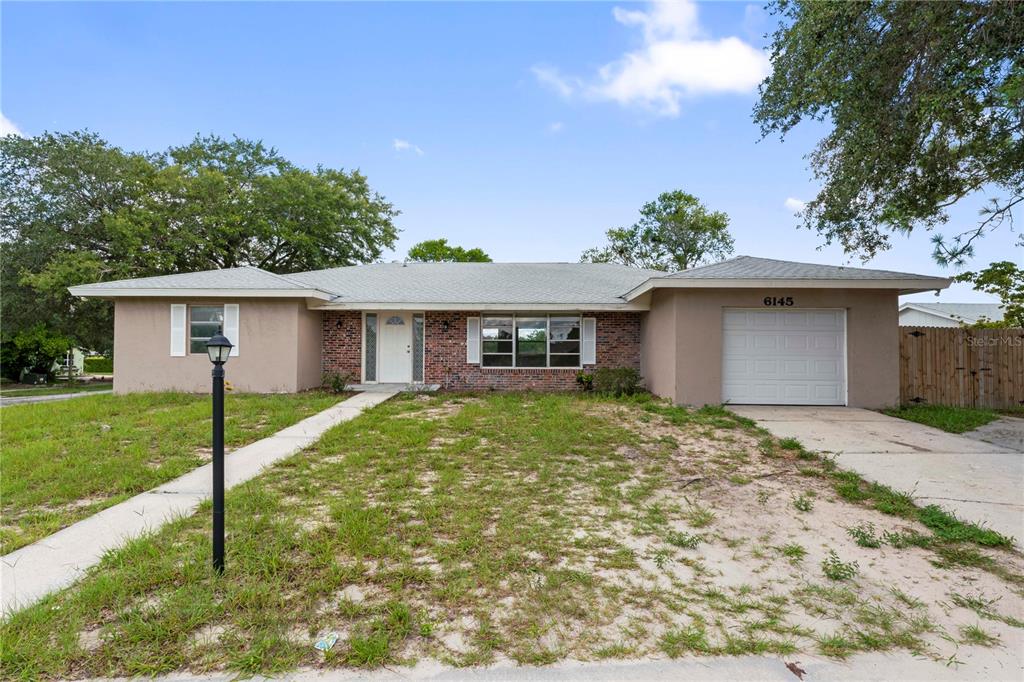 a view of a house with a yard