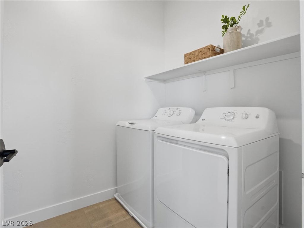 9725 Starlight Ridge Avenue Las Vegas, NV 89148 - Photo 37 of 47 This dedicated space includes a washer and dryer, simplifying your daily routine with efficiency.