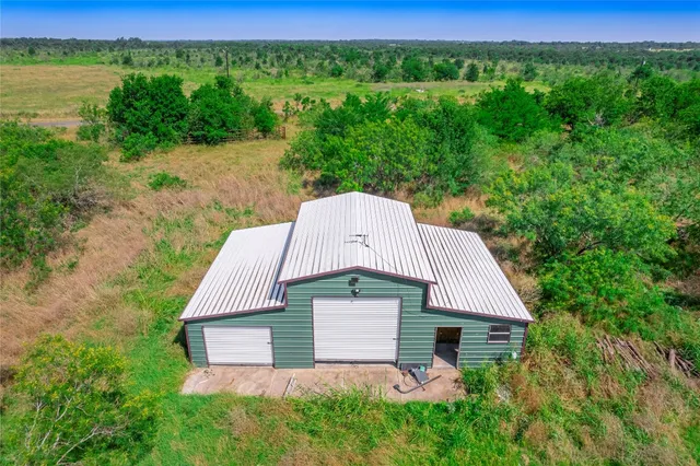 a aerial view of a house next to a yard