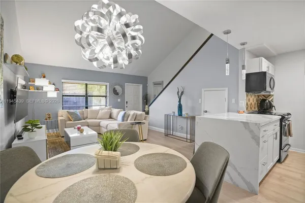 a living room with furniture and a chandelier
