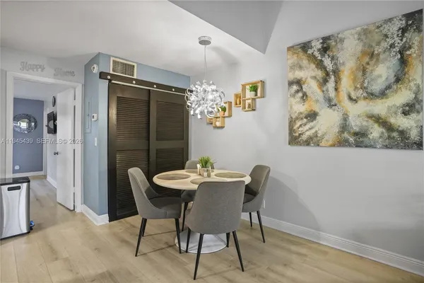 a view of a dining room with furniture and wooden floor