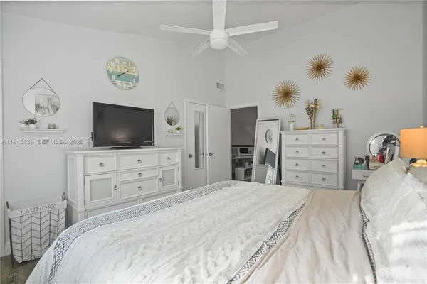 a bedroom with a bed and a flat screen tv in it