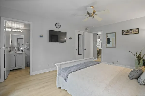 a bedroom with a bed and a television