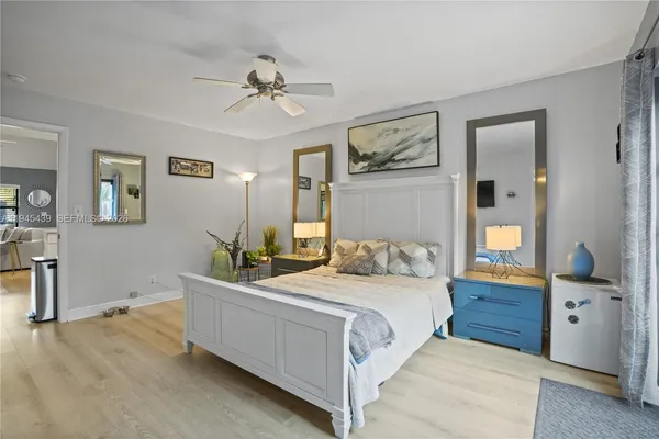 a bedroom with a large bed and a chandelier
