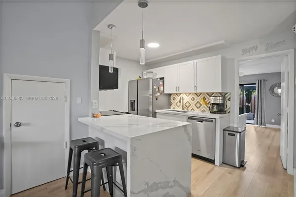 a kitchen with a table and chairs