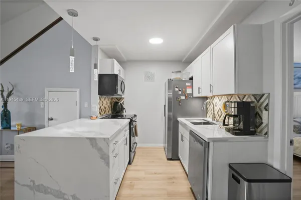 a kitchen with a sink stove and refrigerator