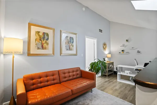 a living room with furniture a couch and a potted plant