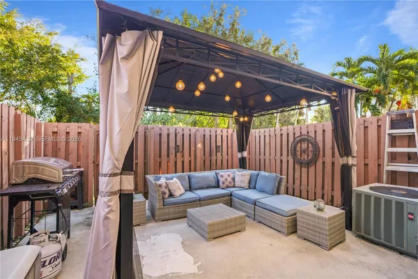 a view of patio with a table and chairs