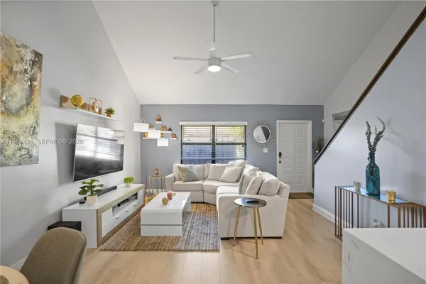 a living room with furniture and a flat screen tv