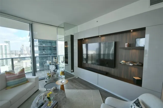 a living room with furniture and a floor to ceiling window