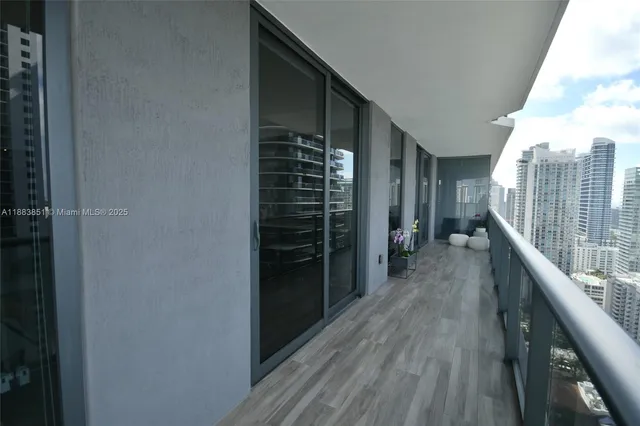 a view of hallway with wooden floor