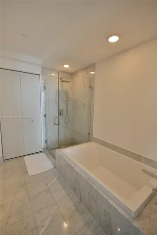 a bathroom with a shower and a tub