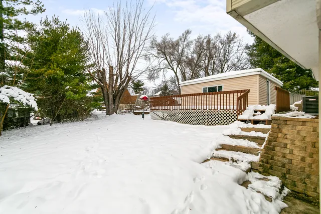a view of a house with a snow in the yard
