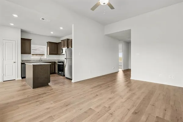 a view of kitchen with wooden floor and electronic appliances