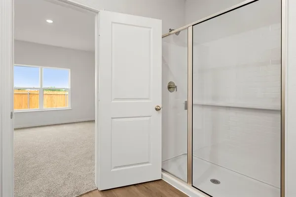 a bathroom with a glass shower door