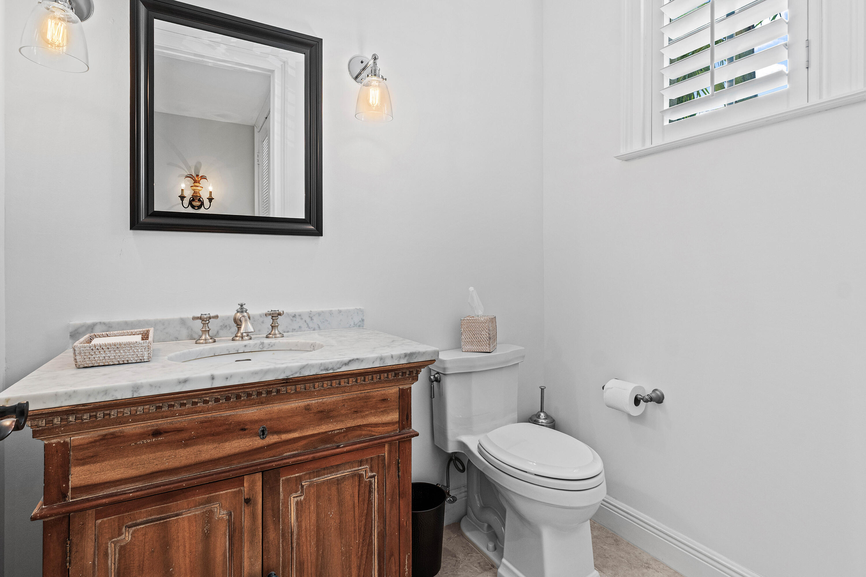 110 Gleason Street, Unit 203 Delray Beach, FL 33483 - Photo 21 of 25 a bathroom with a granite countertop toilet sink and mirror