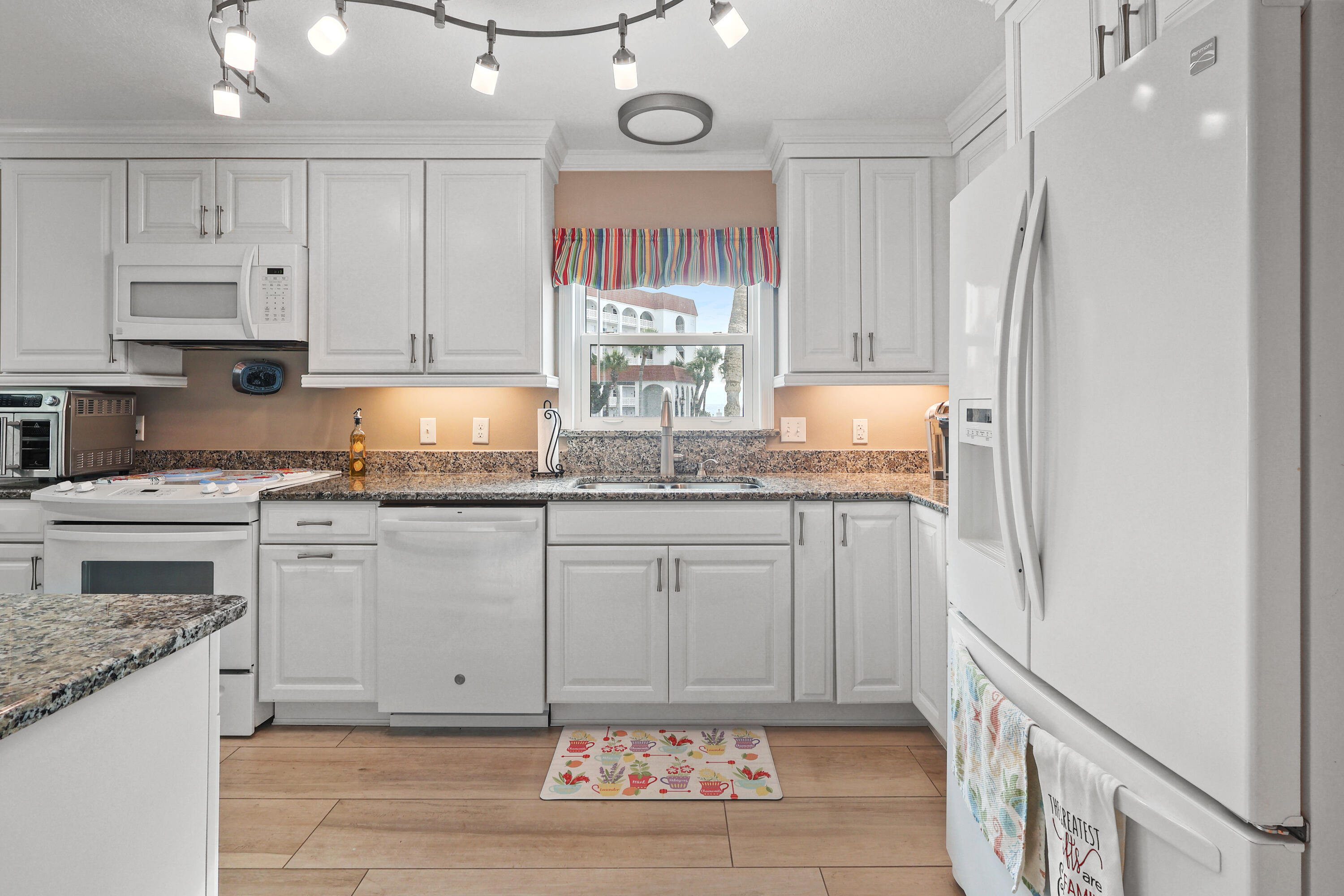 909 Santa Rosa Boulevard, Unit 229 Fort Walton Beach, FL 32548 - Photo 11 of 48 a kitchen with stainless steel appliances granite countertop a stove and white cabinets