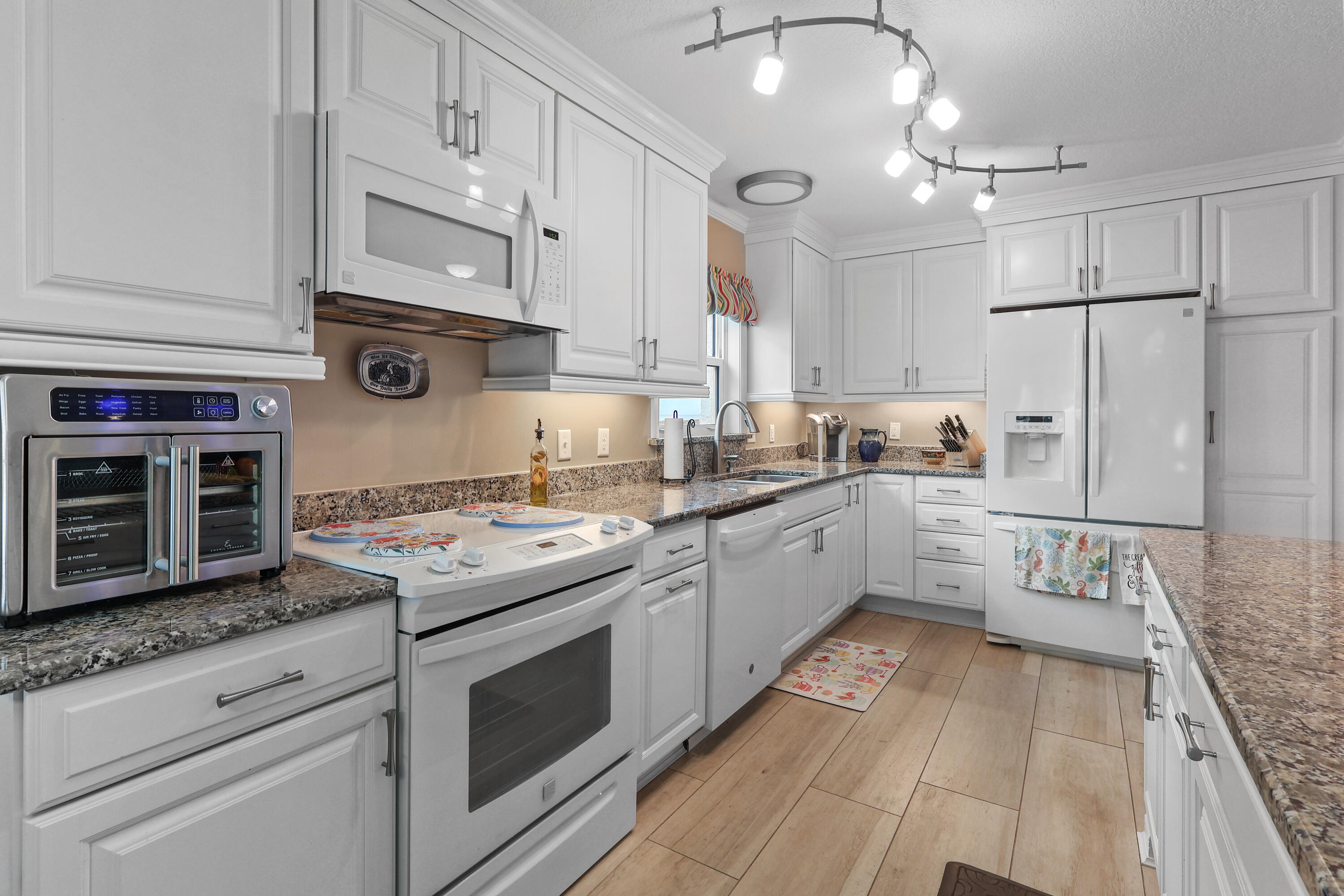909 Santa Rosa Boulevard, Unit 229 Fort Walton Beach, FL 32548 - Photo 18 of 48 a kitchen with stainless steel appliances granite countertop a stove a sink and a refrigerator