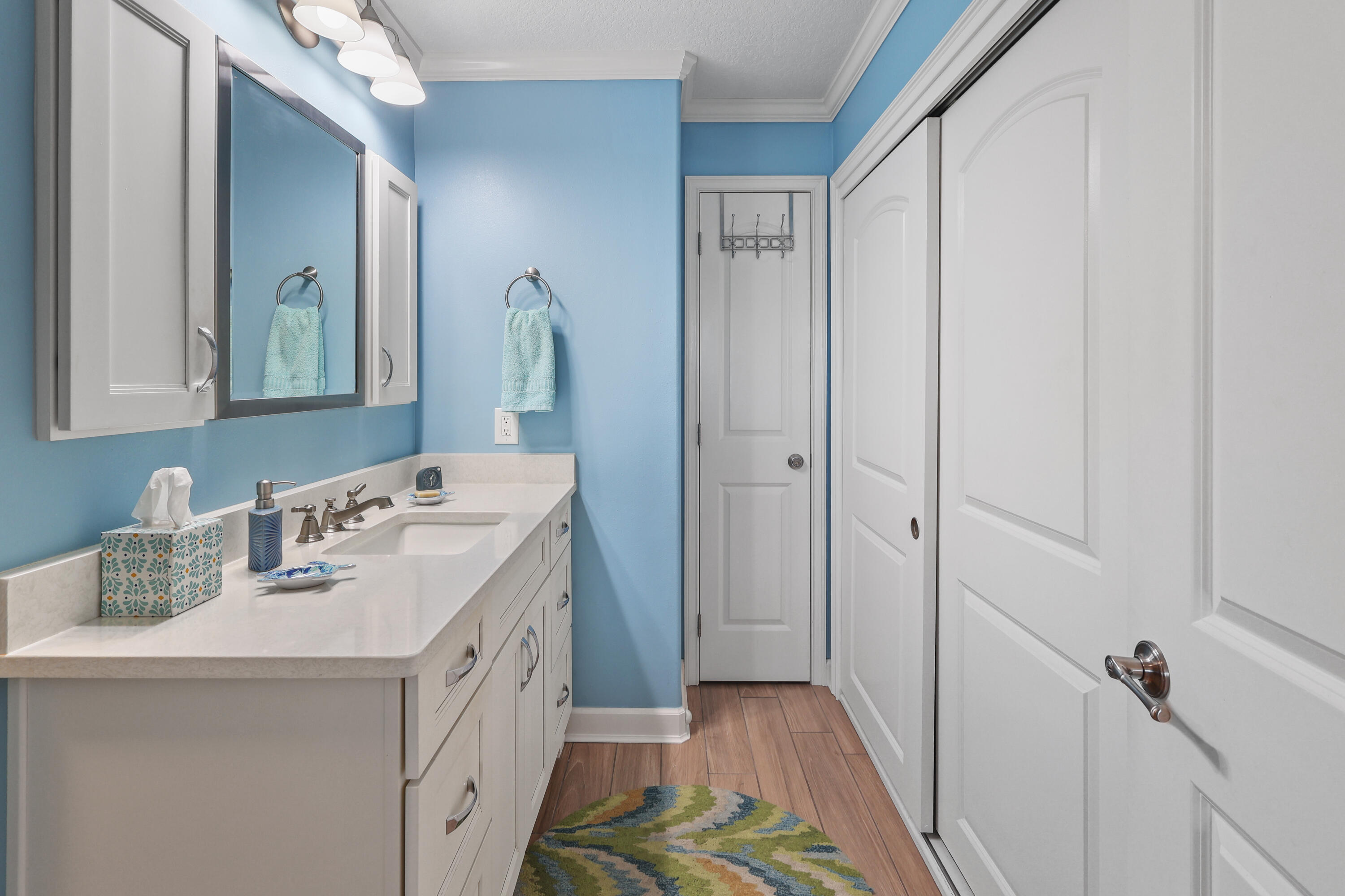909 Santa Rosa Boulevard, Unit 229 Fort Walton Beach, FL 32548 - Photo 27 of 48 a bathroom with a sink a vanity and a mirror