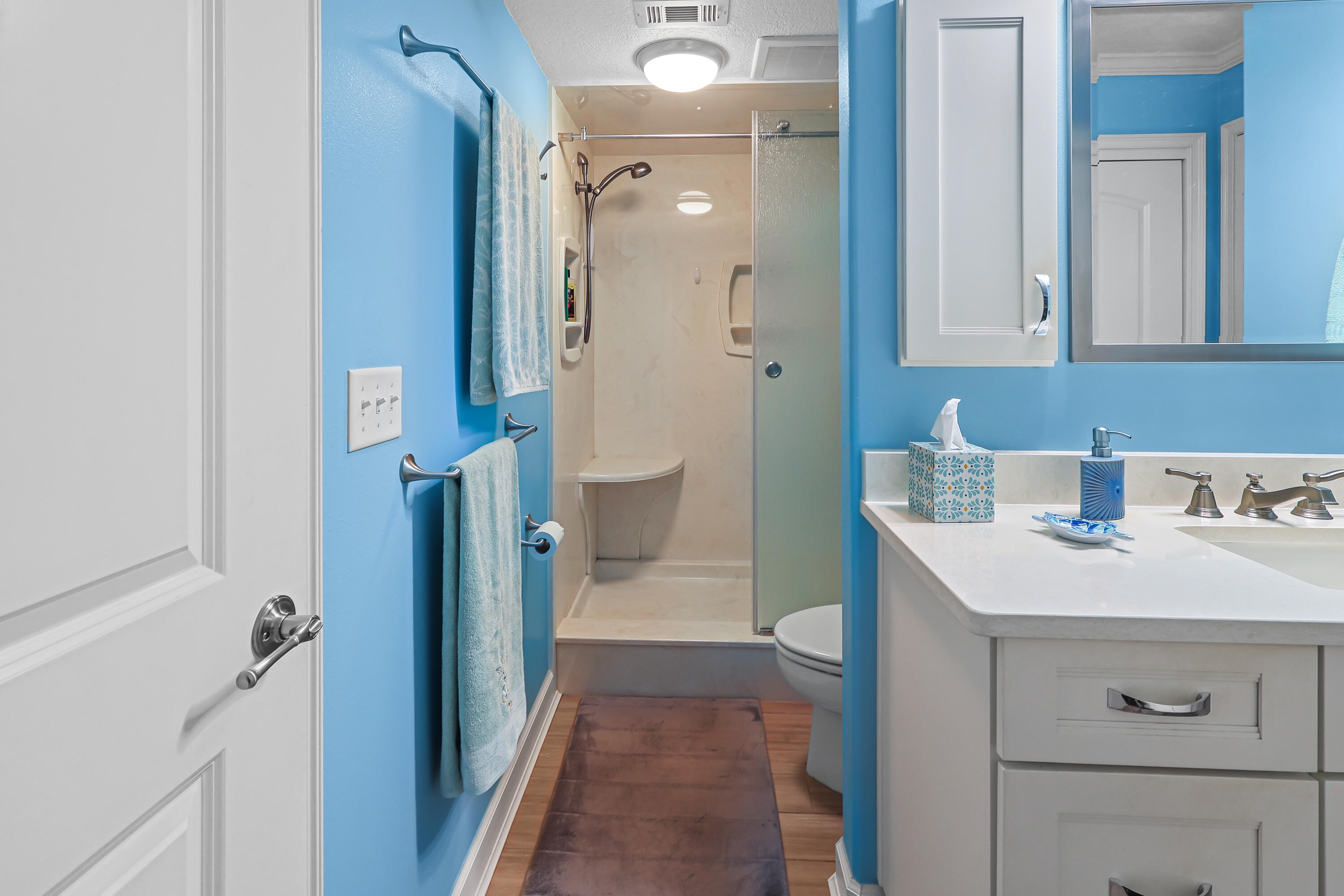 909 Santa Rosa Boulevard, Unit 229 Fort Walton Beach, FL 32548 - Photo 28 of 48 a bathroom with a sink a mirror and a shower