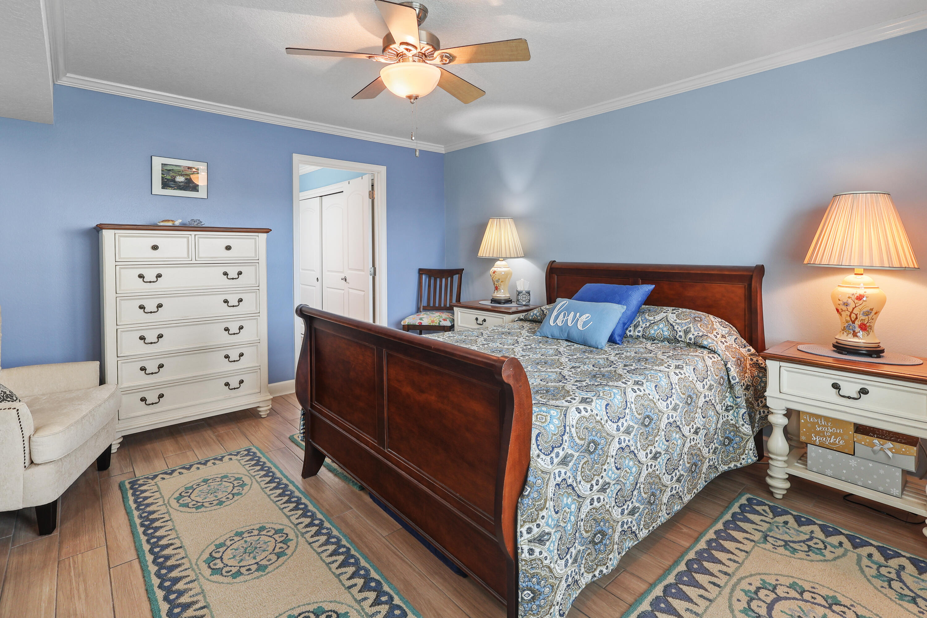909 Santa Rosa Boulevard, Unit 229 Fort Walton Beach, FL 32548 - Photo 6 of 48 a bedroom with a bed and a lamp on dresser