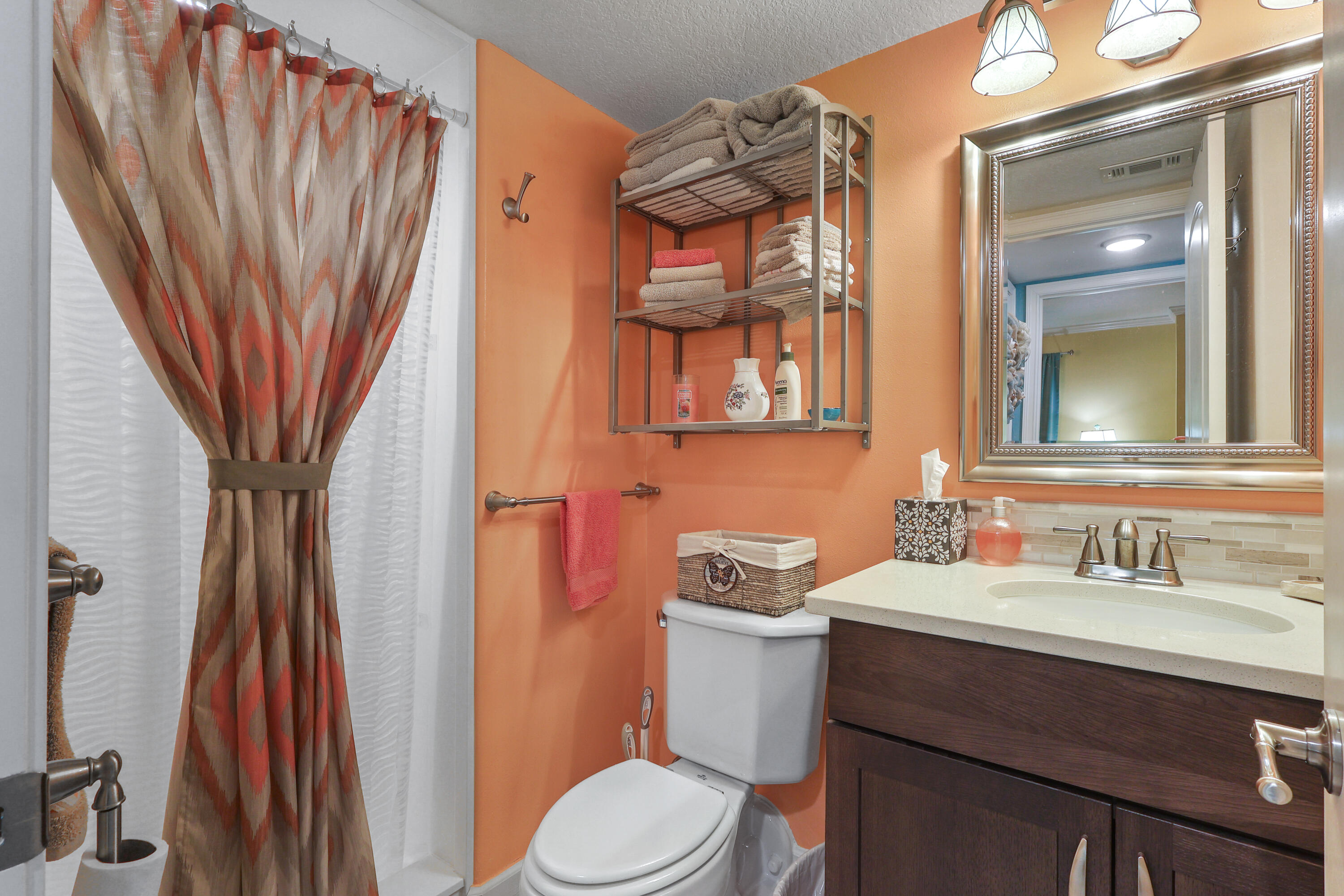 909 Santa Rosa Boulevard, Unit 229 Fort Walton Beach, FL 32548 - Photo 9 of 48 a bathroom with a sink a toilet and shower curtain