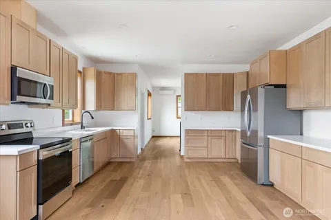 a kitchen with a sink cabinets and stainless steel appliances