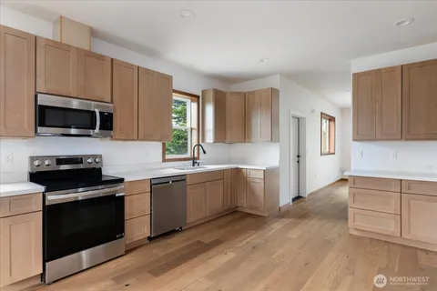 a kitchen with a stove a sink and a microwave