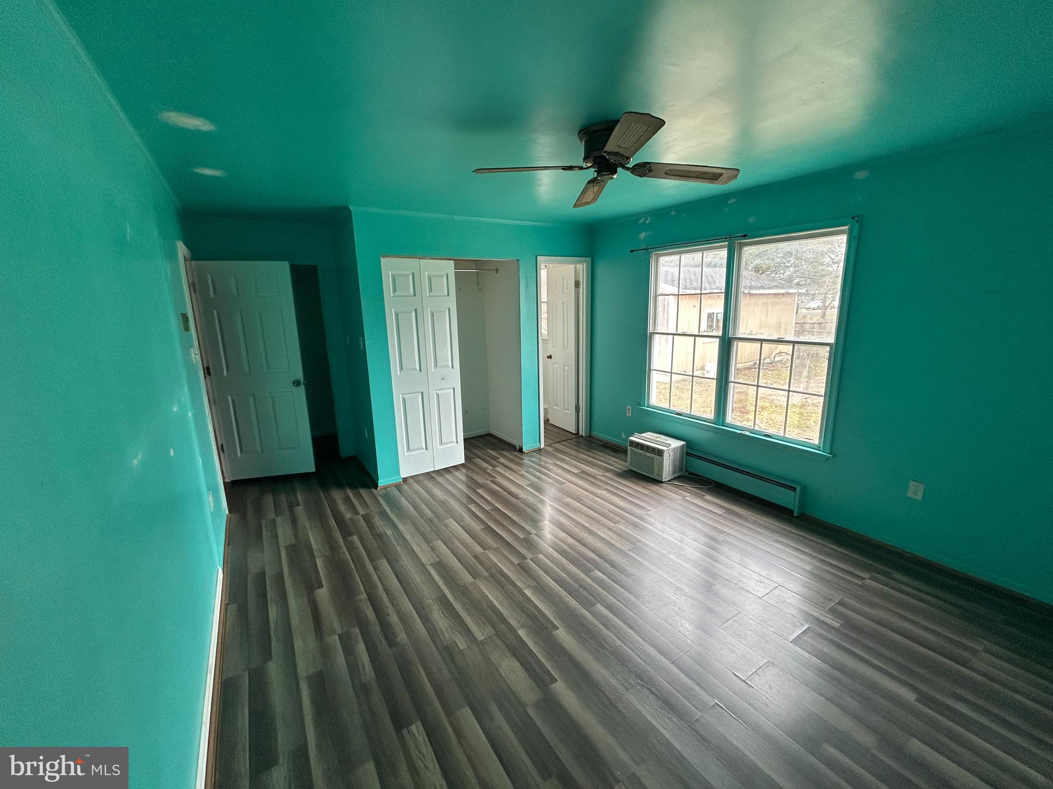 608 Spring Garden Avenue Salisbury, MD 21804 - Photo 8 of 19 a view of an empty room with a window and wooden floor