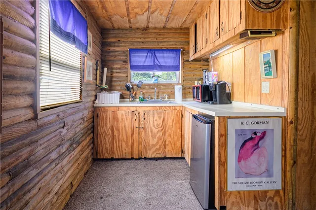 a bathroom with a sink a mirror and shower curtain