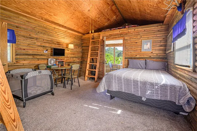 a bed room with a bed and a chair