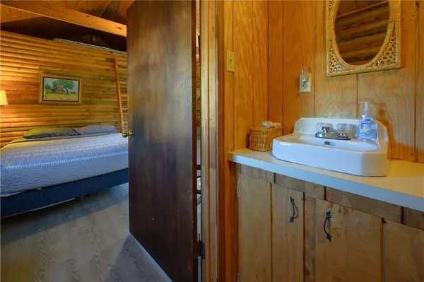 a bed room with a bed and a chair