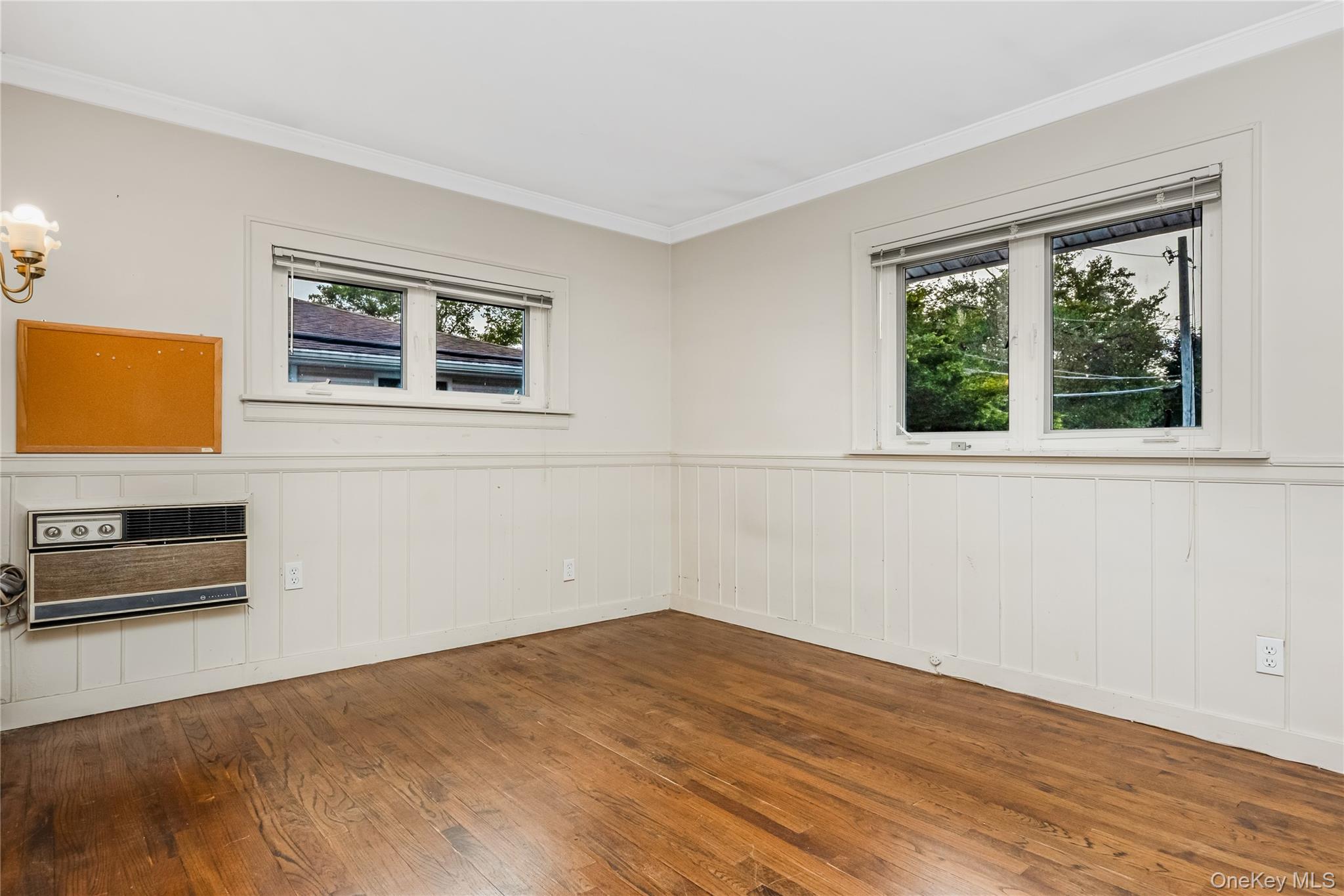 29 Randy Lane Plainview, NY 11803 - Photo 29 of 38 Wood-finish flooring with white wainscoting and crown molding