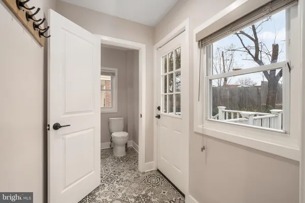 a view of a bathroom with a toilet and a window
